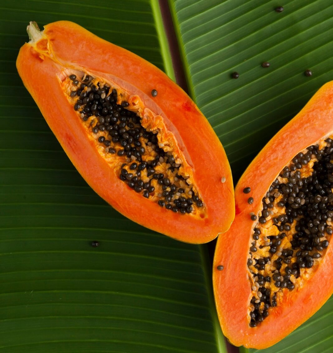 sliced papaya on green banana leaf